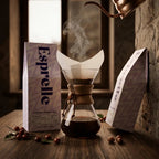 Esprelle coffee bag with a Chemex coffee maker and coffee beans on a wooden surface.